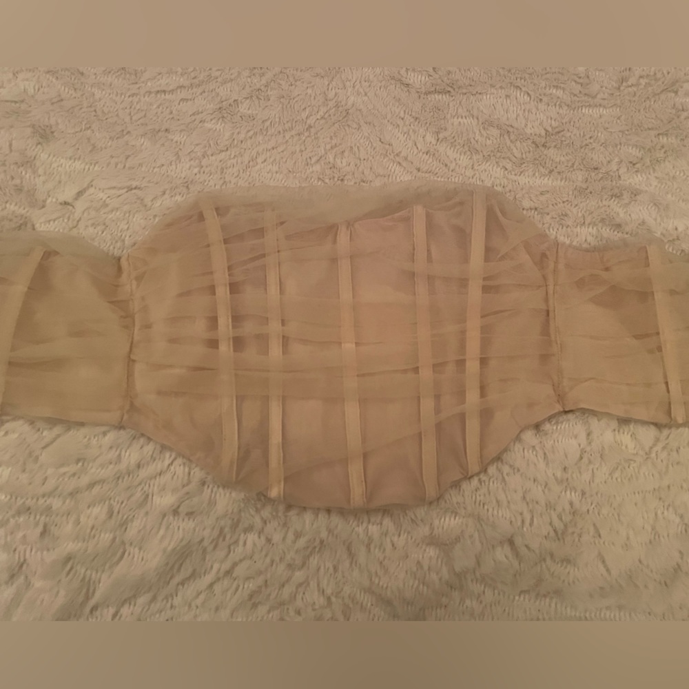 Tube top, mash but not see-through. Very cute. White fox